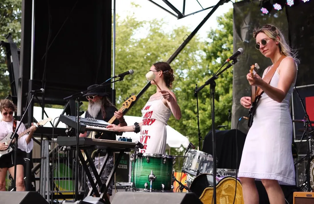 Band duchess performing outdoors on a festival stage in daylight.